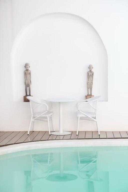 a table and two chairs next to a swimming pool at bassa resort in Panglao Island