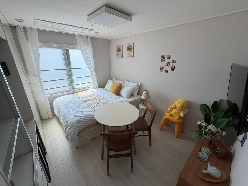 a small bedroom with a bed and a table at 여유스테이 in Suwŏn-yŏk