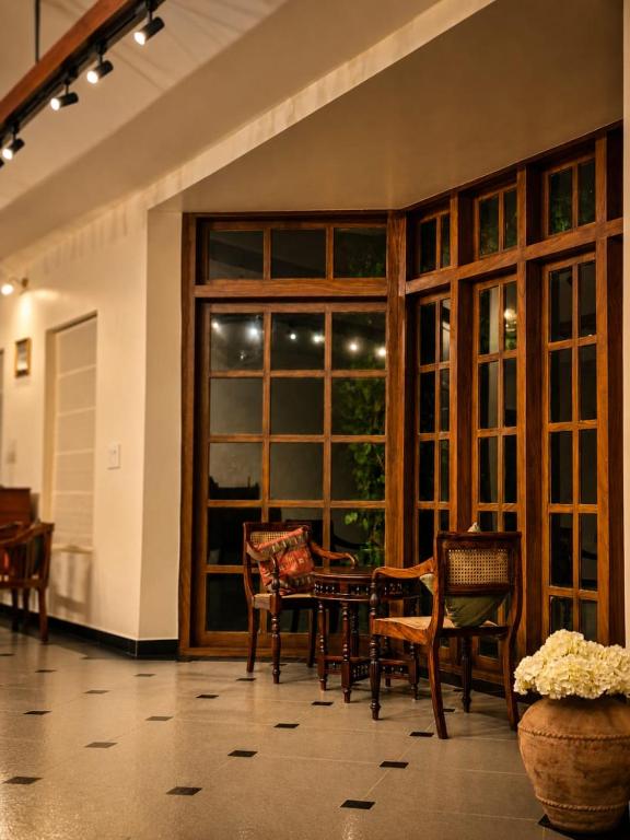 a room with a table and chairs and a large window at Nine Pines in Pīrmed