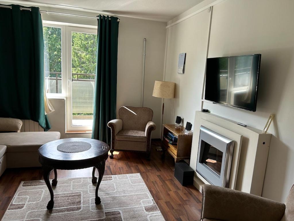 a living room with a fireplace and a tv at Kuremaa Lake in Kuremaa