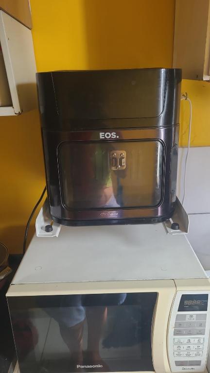 a black microwave sitting on top of a microwave oven at Joy Apartamento completo in Salvador