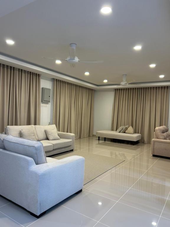 a living room with two couches and a table at Haus176 in Bentong