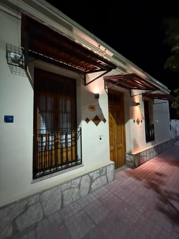 a house with a door and a porch at night at Casa de Adobe Doña Tinogasta in Tinogasta