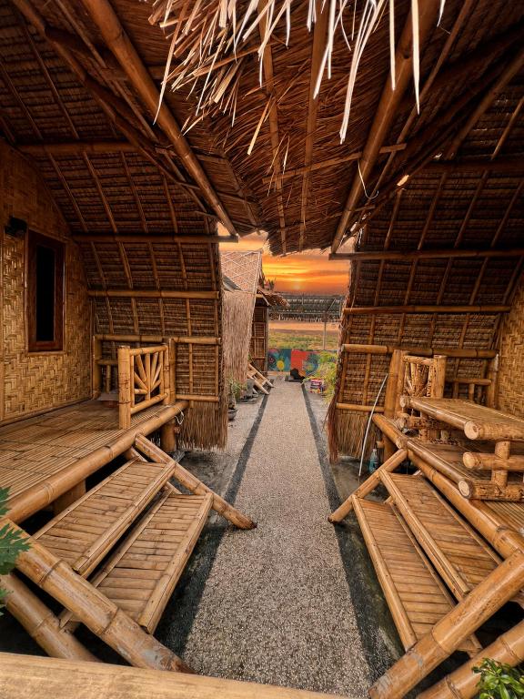 a room with a building with wooden floors and ceilings at The Twins Sunset Bungalow in Ekas
