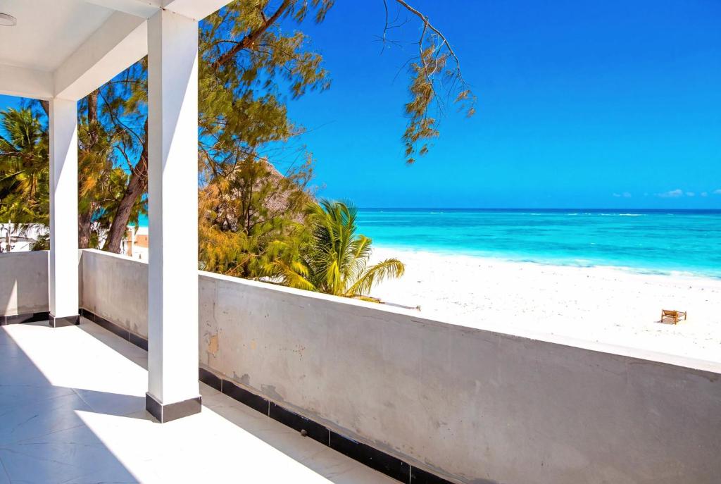 a view of the beach from the balcony of a house at Ocean-View Balcony - Uroa 2 bedroom Beachfront apt in Uroa