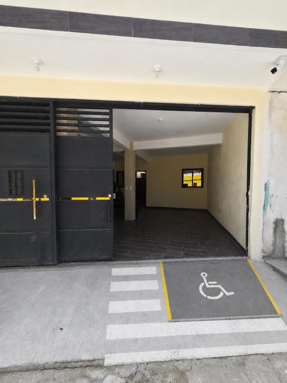 an empty parking garage with a handicapped sign on the ground at Guadalupe House Esquipulas in Esquipulas