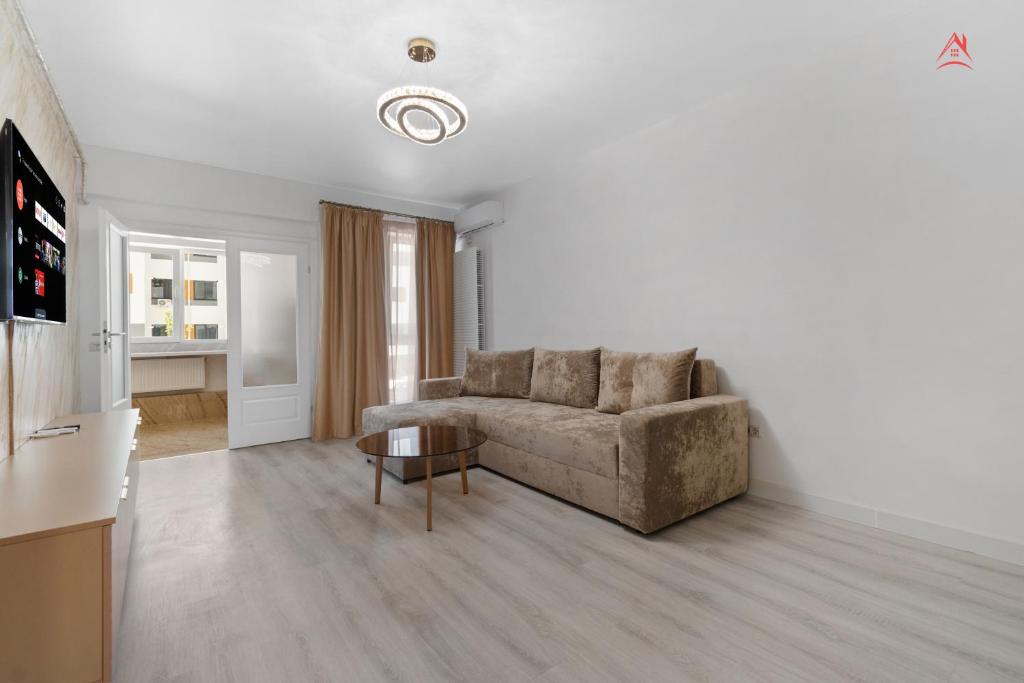 a living room with a couch and a table at Vibe Luxury Studio - Militari Residence - Parcare Privata Gratuita in Chiajna