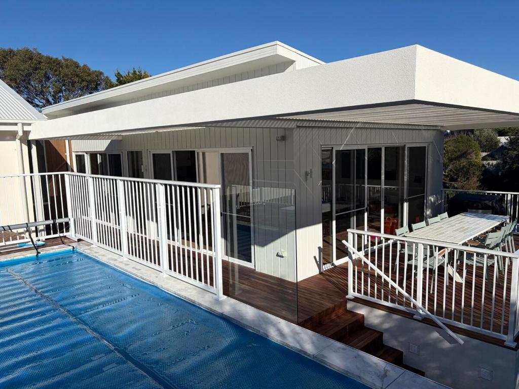 a house with a swimming pool and a deck at Tiberius House in Saint Andrews Beach
