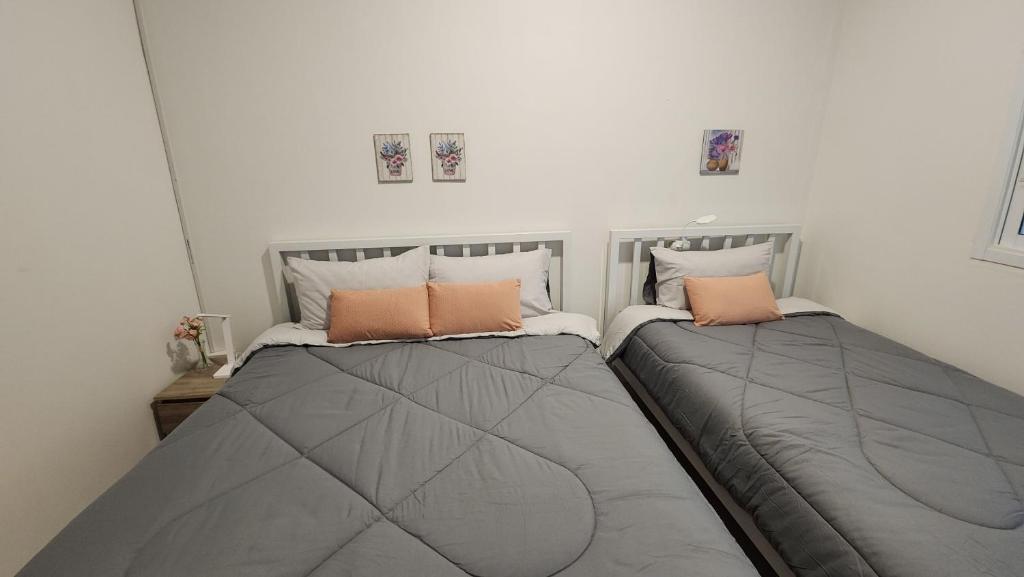 two beds sitting next to each other in a bedroom at 338 House in Ban Liam