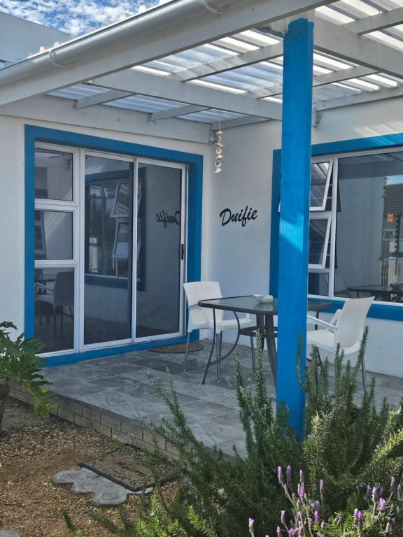 a patio with a table and chairs on it at The Somerset nest in Cape Town