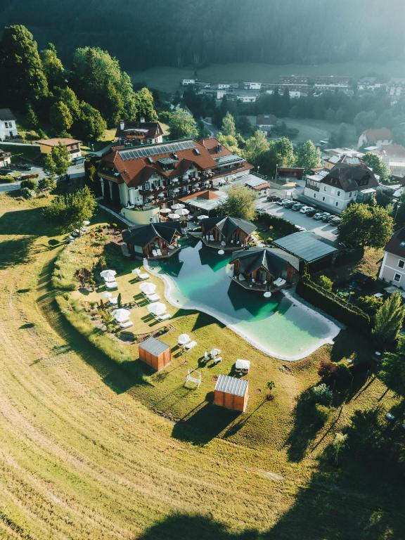 an aerial view of a resort with a pool at ROHO MURAU Hotel Rosenhof Murau in Murau