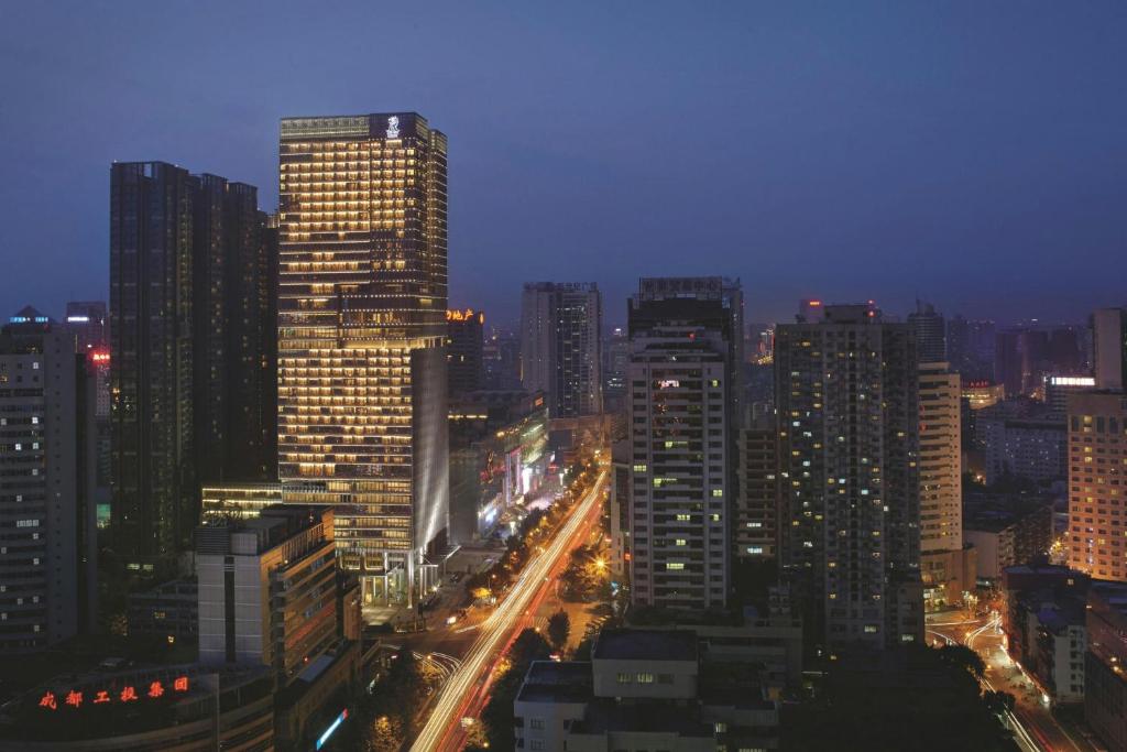 a city lit up at night with buildings at The Ritz-Carlton, Chengdu in Chengdu