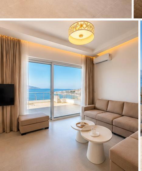 a living room with a couch and a large window at Apartment Katherina Sarande in Sarandë