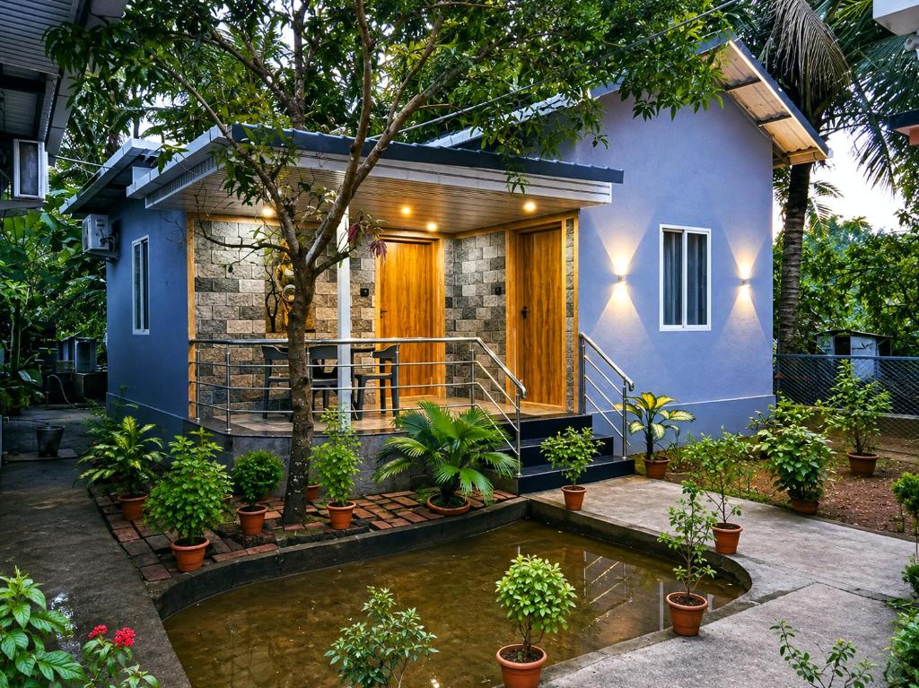 a house with a pond in front of it at Shilpa Serenity in Kāsarkod