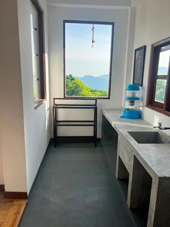 a bathroom with a sink and a large window at Green Mount View Cottage in Ella
