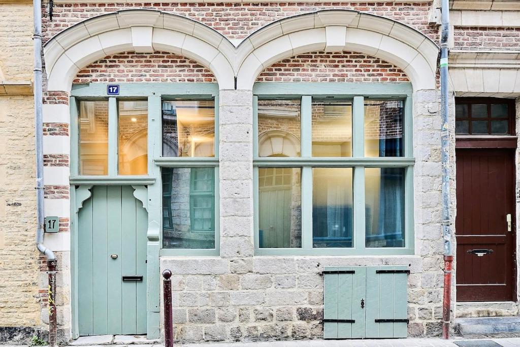 two windows and two doors on a brick building at Exceptional double house with Jacuzzi in Lille