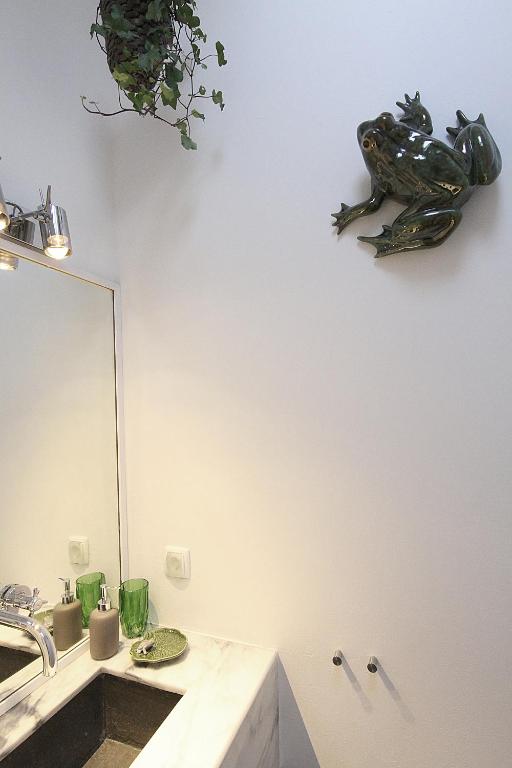 a bathroom with a sink and a frog on the wall at Senhora do Cabo Meco Homy Holidays in Sesimbra