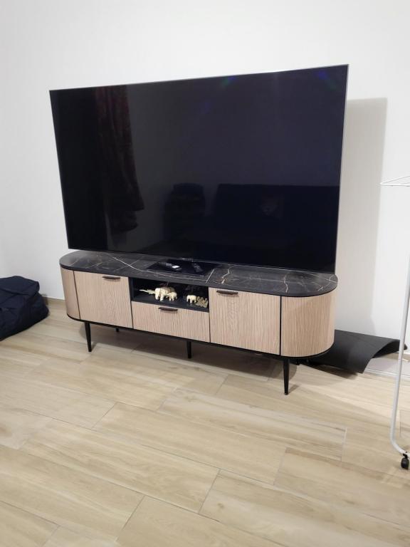 a living room with a large flat screen tv at Valle du mezzane in Valle-di-Mezzana