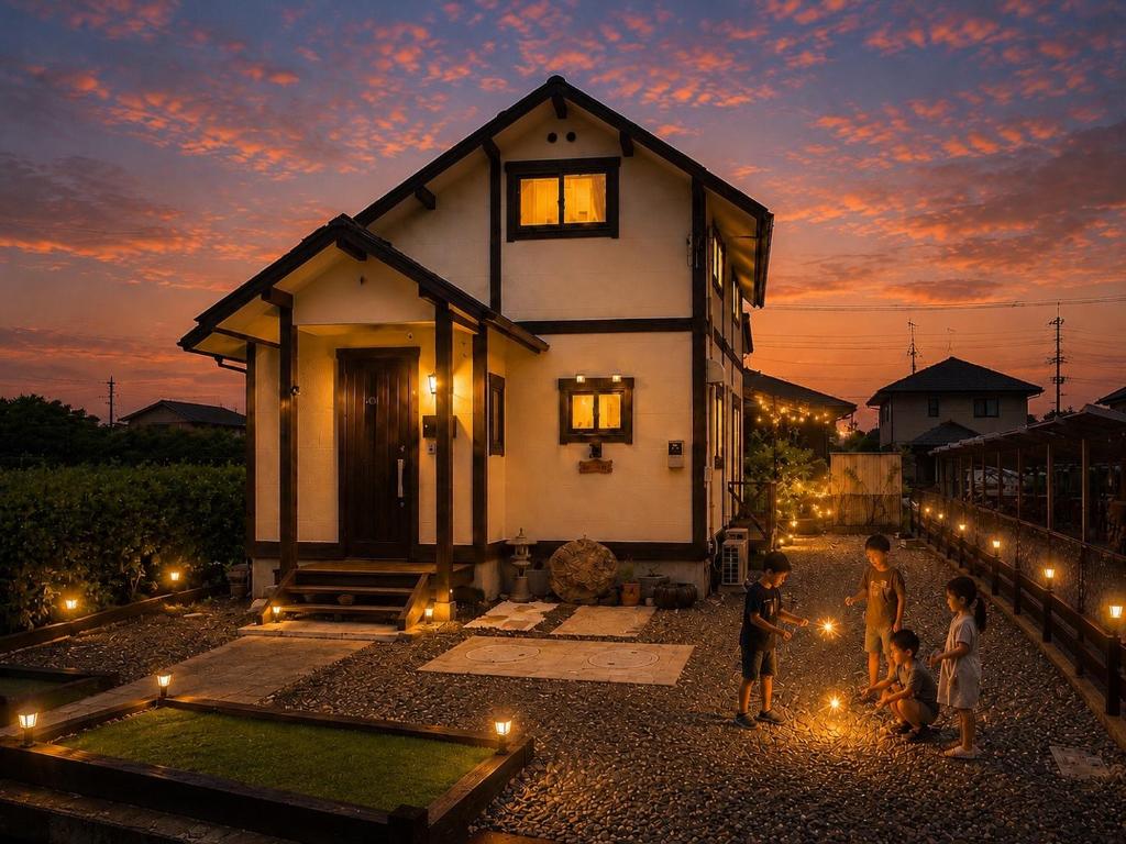 a group of people standing outside of a house with lights at Hamabun テラスでBBQ 湖まで徒歩5分 無料駐車場3台 in Takashima