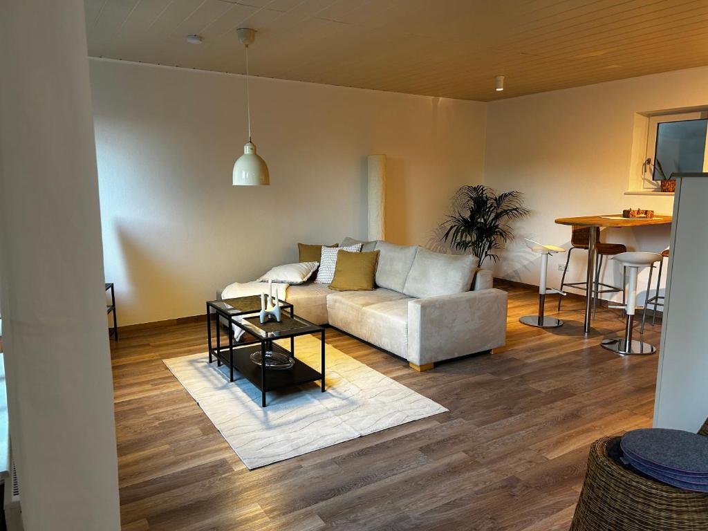 a living room with a couch and a table at Wohnung mit Terrasse in Hirschaid