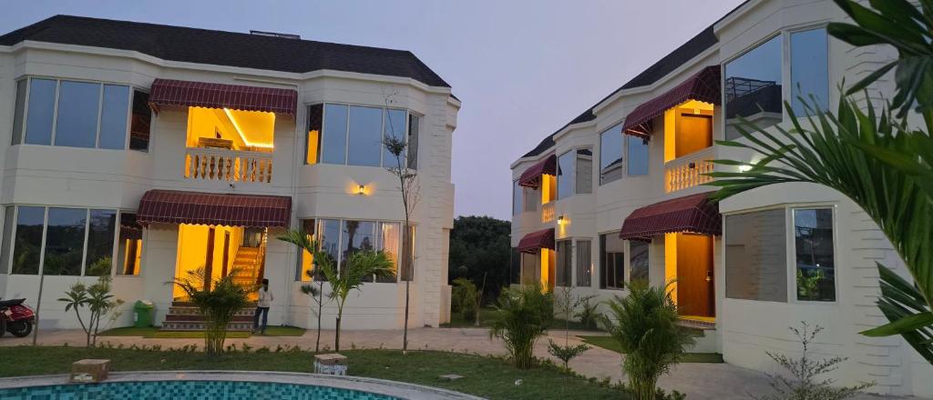 a building with a pool in front of it at Parinay Pavilion LLP in Bahraich