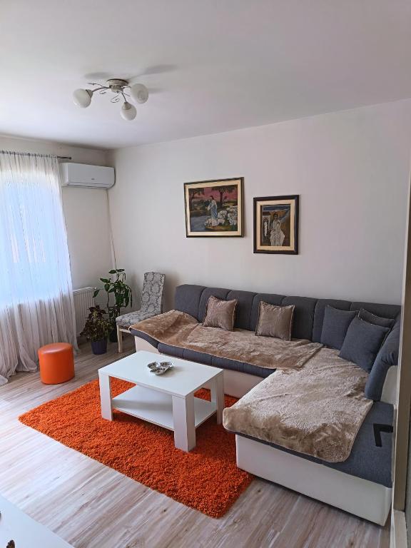 a living room with a couch and a table at Stan na dan in Pljevlja