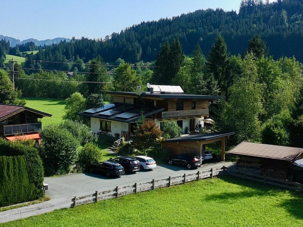 a house with cars parked in a parking lot at Appartements Skida in Reith bei Kitzbühel