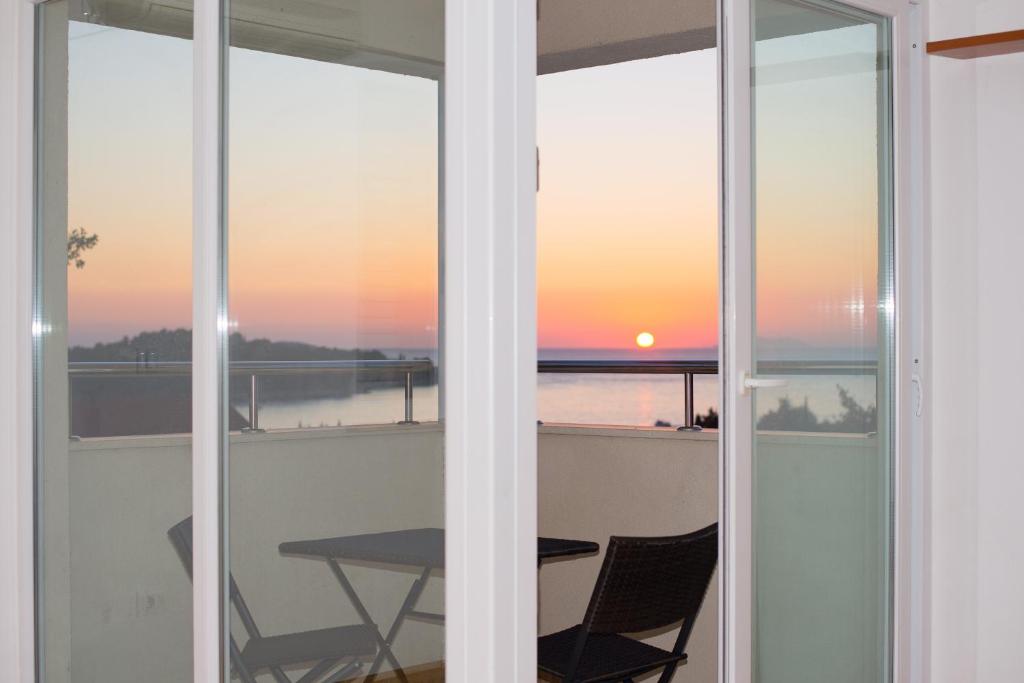 a view of a sunset from the balcony of a house at A&M Cavtat, sunset 3 bedrooms apartment with parking in Cavtat