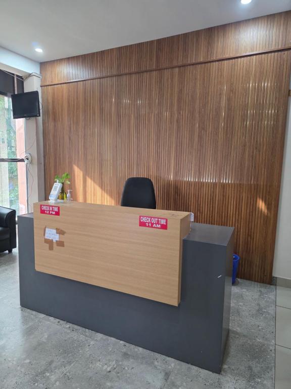 an office cubicle with a desk and a chair at Barza Inn in Kakkanad