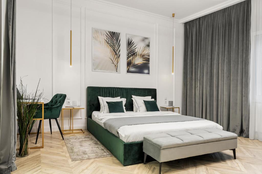 a bedroom with a green bed and a desk at Downtown Bucharest Villa Private Garden & Garage for Parking in Bucharest