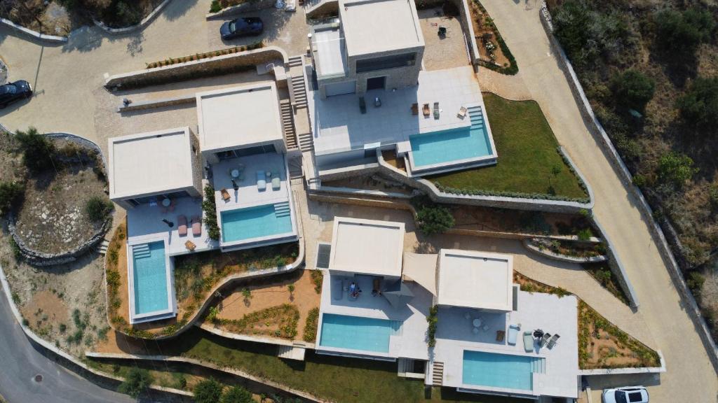 an overhead view of a house with swimming pools at Alos Suites in Verga Kalamata