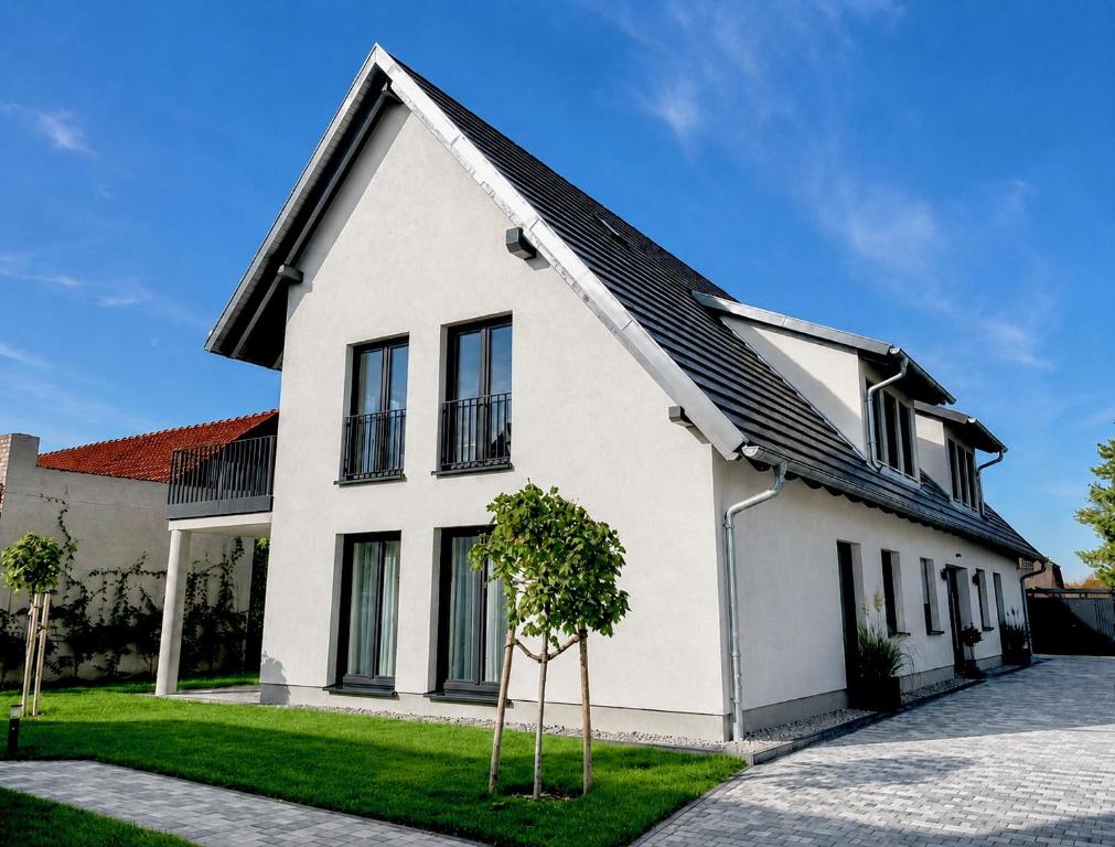 a white house with a black roof at WeberHof Appartements in Burg