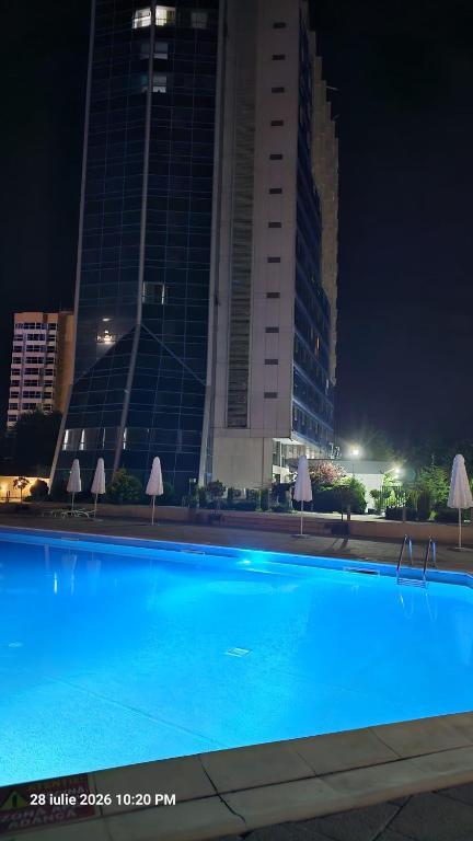 a large blue swimming pool in front of a building at Sea View Ani in Olimp