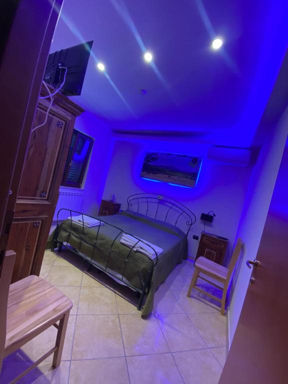 a bedroom with a bed and a purple ceiling at Masseria Frangiosa in Torrecuso