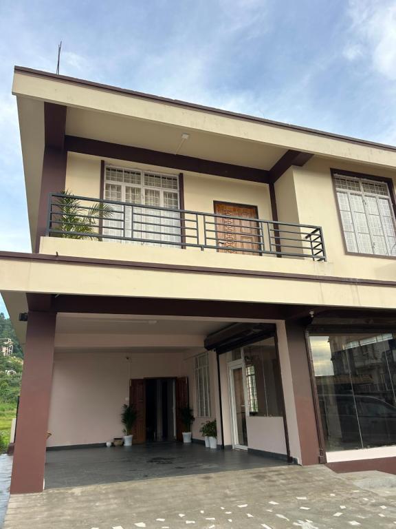 a house with a balcony on top of it at Serenity View Stay in Shillong
