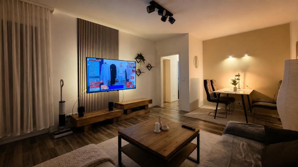 a living room with a large flat screen tv at Moderne liebevolle Ferienwohnung in Bergkamen