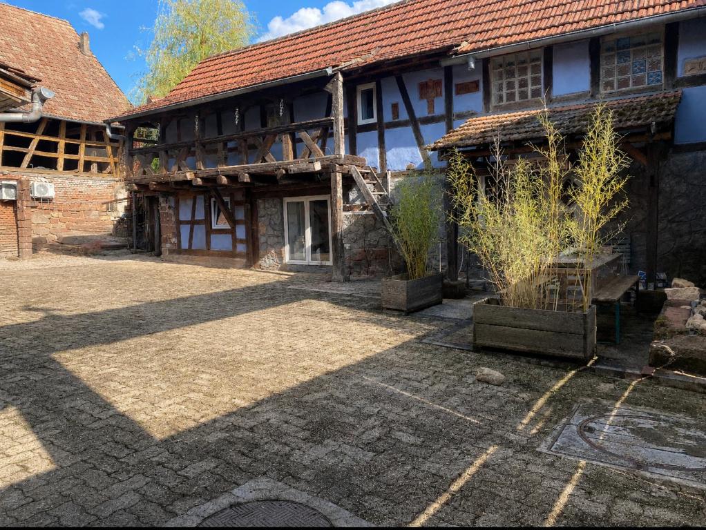 an old building with a courtyard in front of it at Stawalters in Kirrwiller