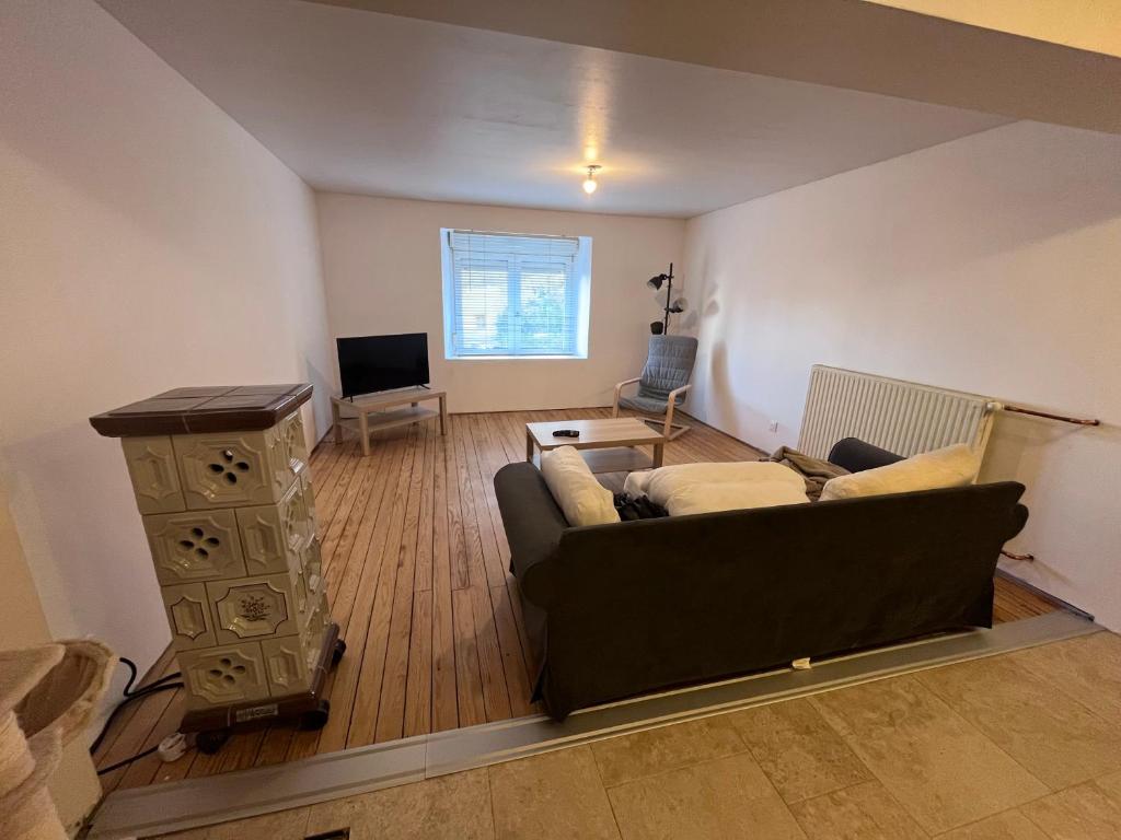 a living room with a couch and a table at Maison 2 chambres 