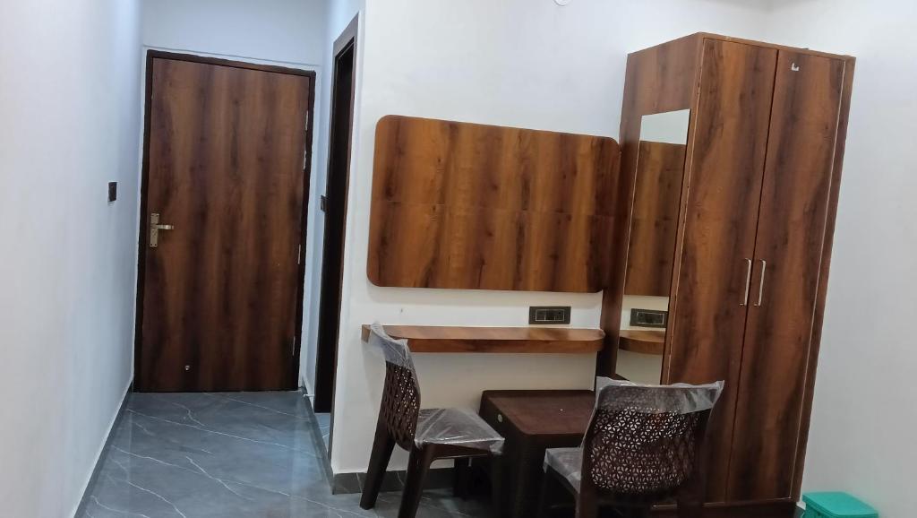 a room with a wooden table and two chairs at Taj wonder inn in Tājganj