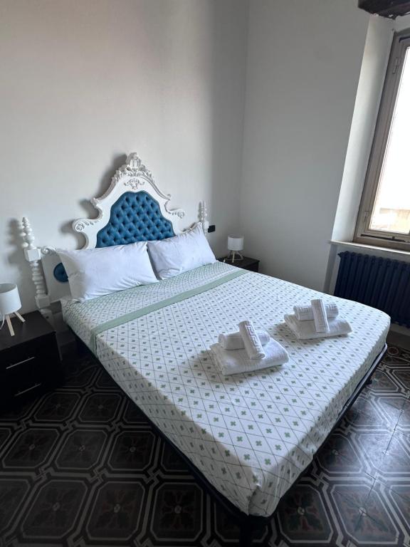 a bedroom with a bed with two towels on it at L'Angolo di Luce in Falconara Marittima