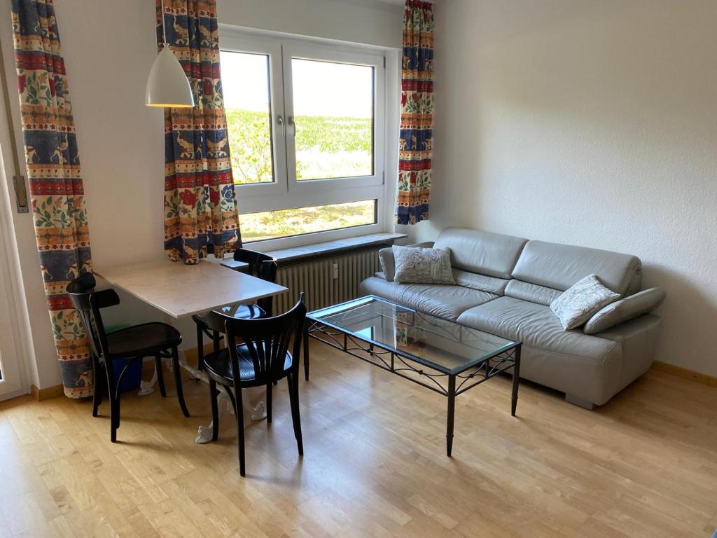 a living room with a couch and a table at Kornblick in Korntal-Münchingen