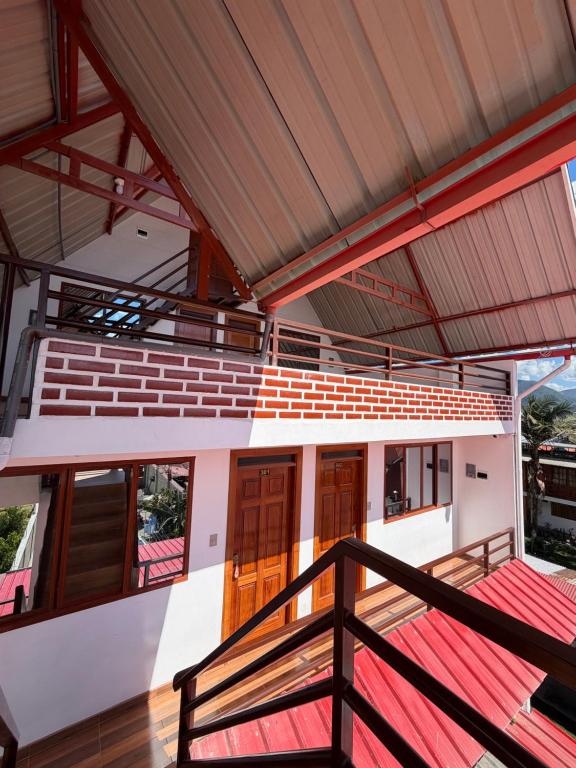 a balcony of a house with wooden doors at La Casita de Merme in Oxapampa