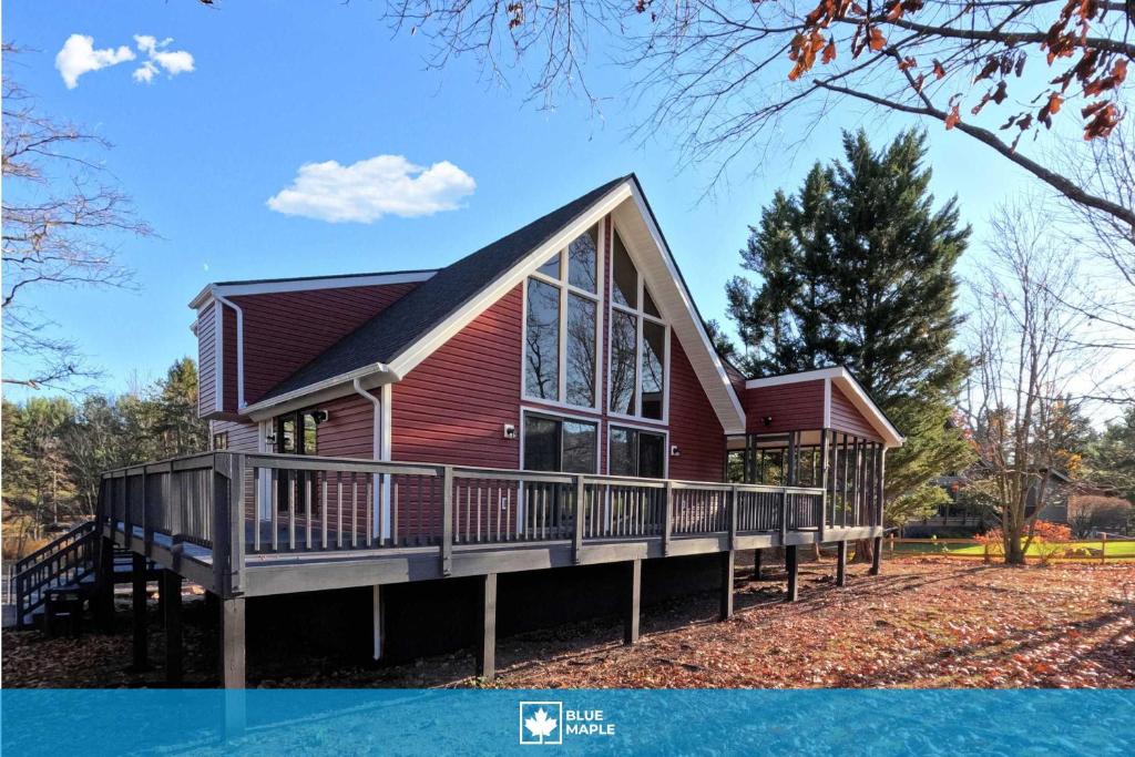 a home with a large deck and a house at Golf Course Views Hot Tub Games & Pool Access in Hedgesville