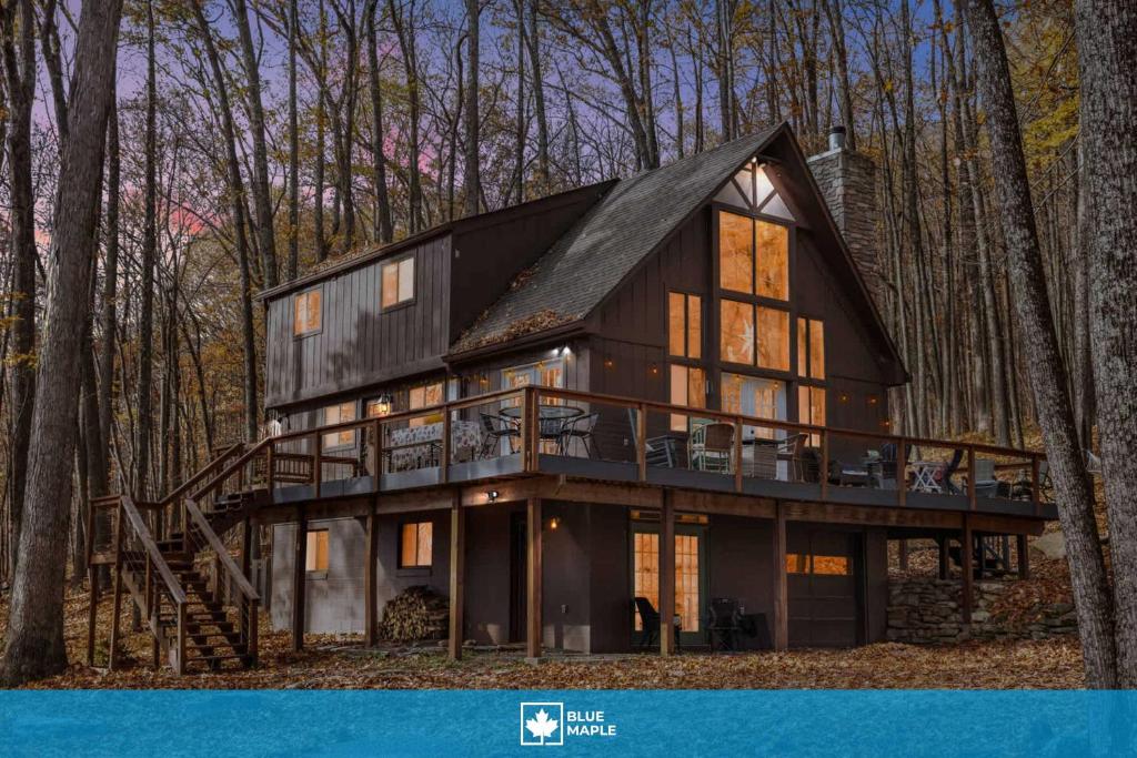 a black house with a gambrel roof at Mountainside w Fireplace, Fire Pit, Deck, & WiFi in Smith Crossroads