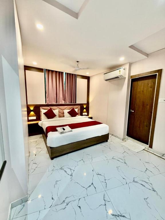 a hotel room with a bed and a marble floor at Classy Comfort NESCO Exhibition Centre - Business Hotel in Mumbai