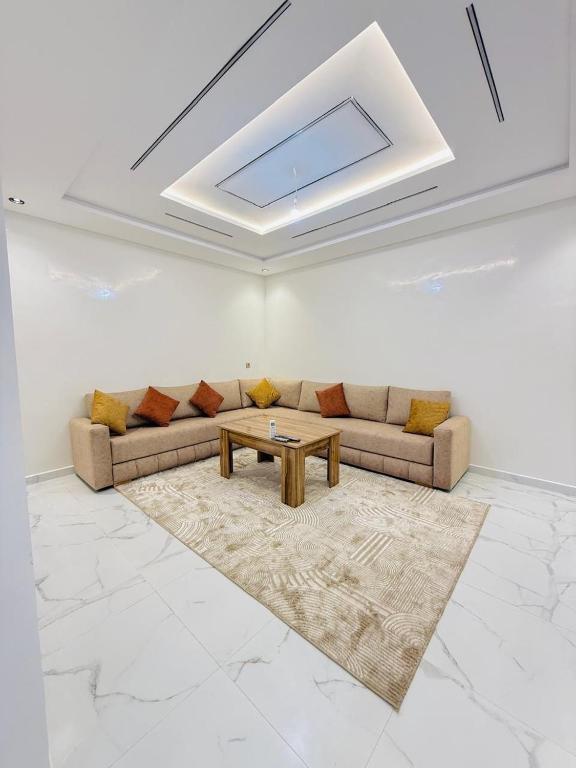 a living room with a couch and a table at Manifique renovated apartment Marrakech in Marrakesh
