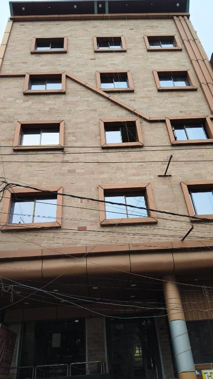 a tall brick building with many windows on it at hotel darbar international in Gaya
