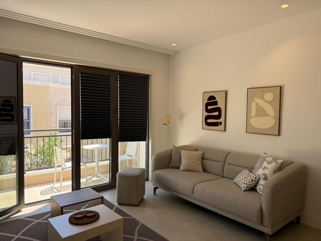 a living room with a couch and a large window at Charming studio-plus in Lustica Bay Centrale in Radovici