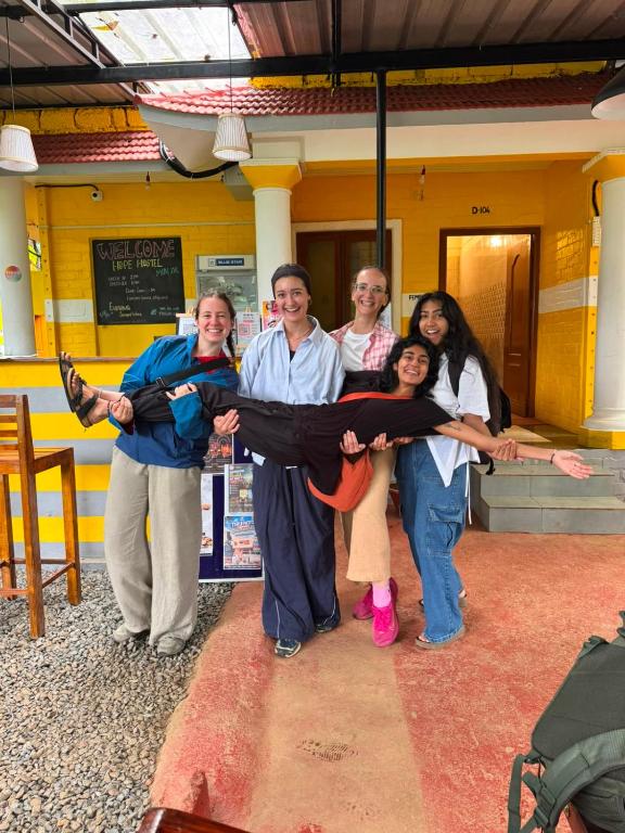 a group of people holding up a ribbon at Hope Hostels - Munnar in Munnar