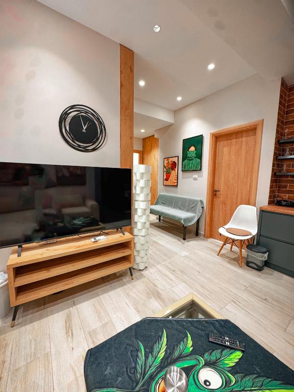 a living room with a large flat screen tv at Lost At Sea 2 in Sarandë